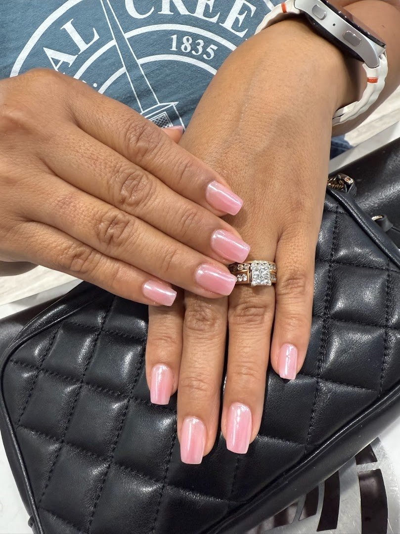 Manicured nails displayed in a salon setting.